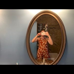 Open back romper, orange/rust color with flowers.